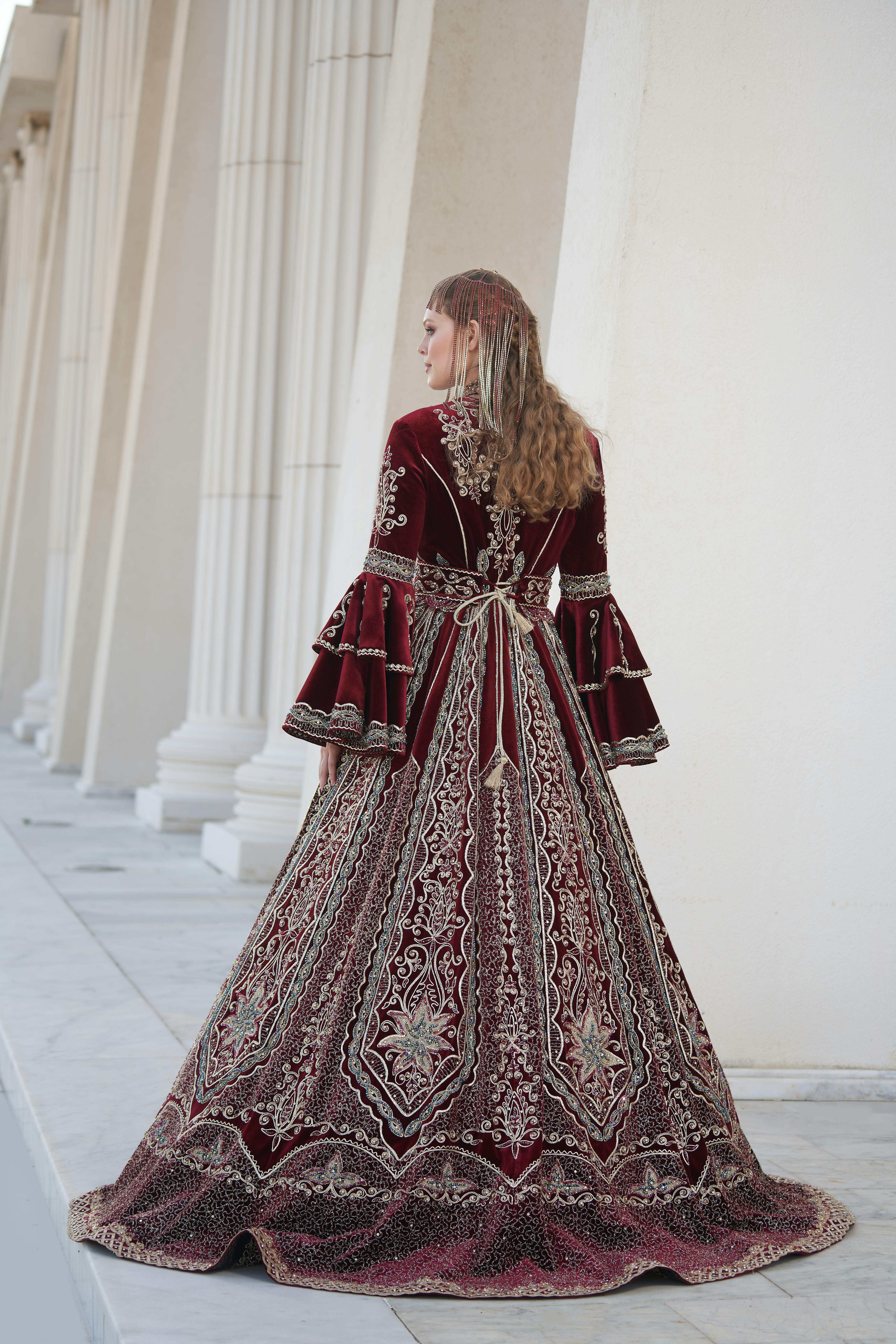 Stunning burgundy and silver bridal gown with intricate embroidery, captured outdoors in İzmir, Türkiye.