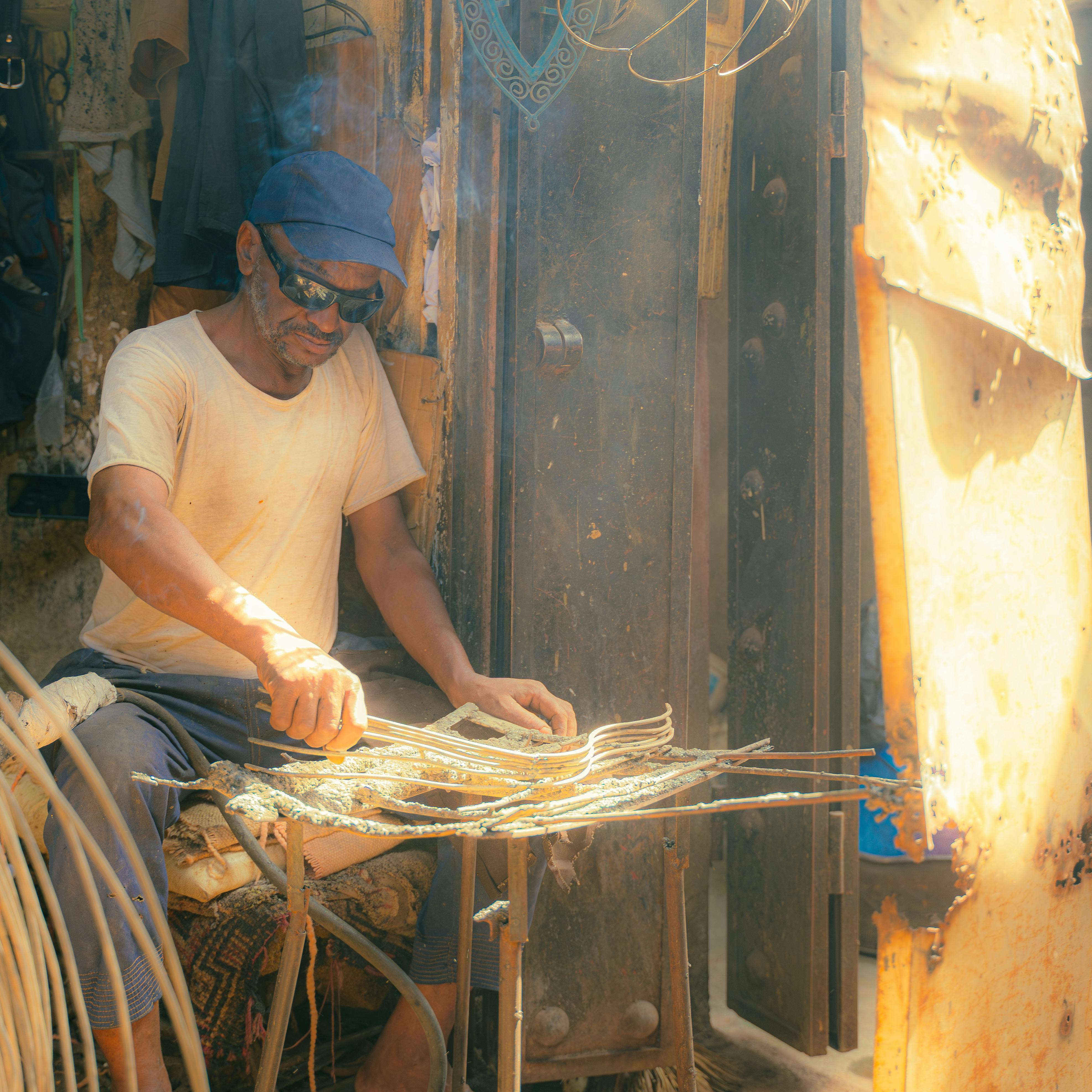 Local artisan skillfully crafting in a Marrakech workshop, showcasing traditional techniques.