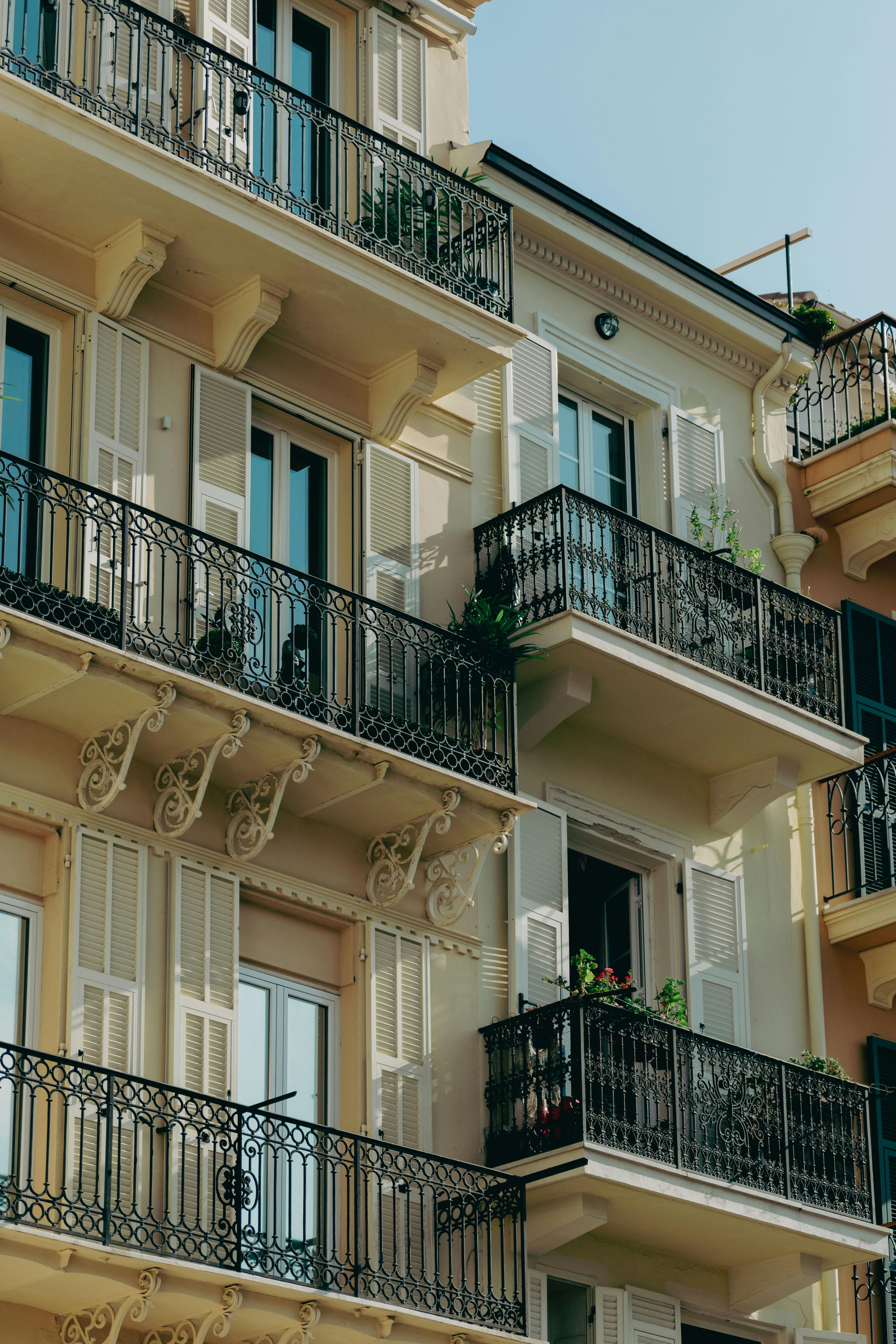 Elegant balconies on a classic Mediterranean-style building in sunny Monaco.