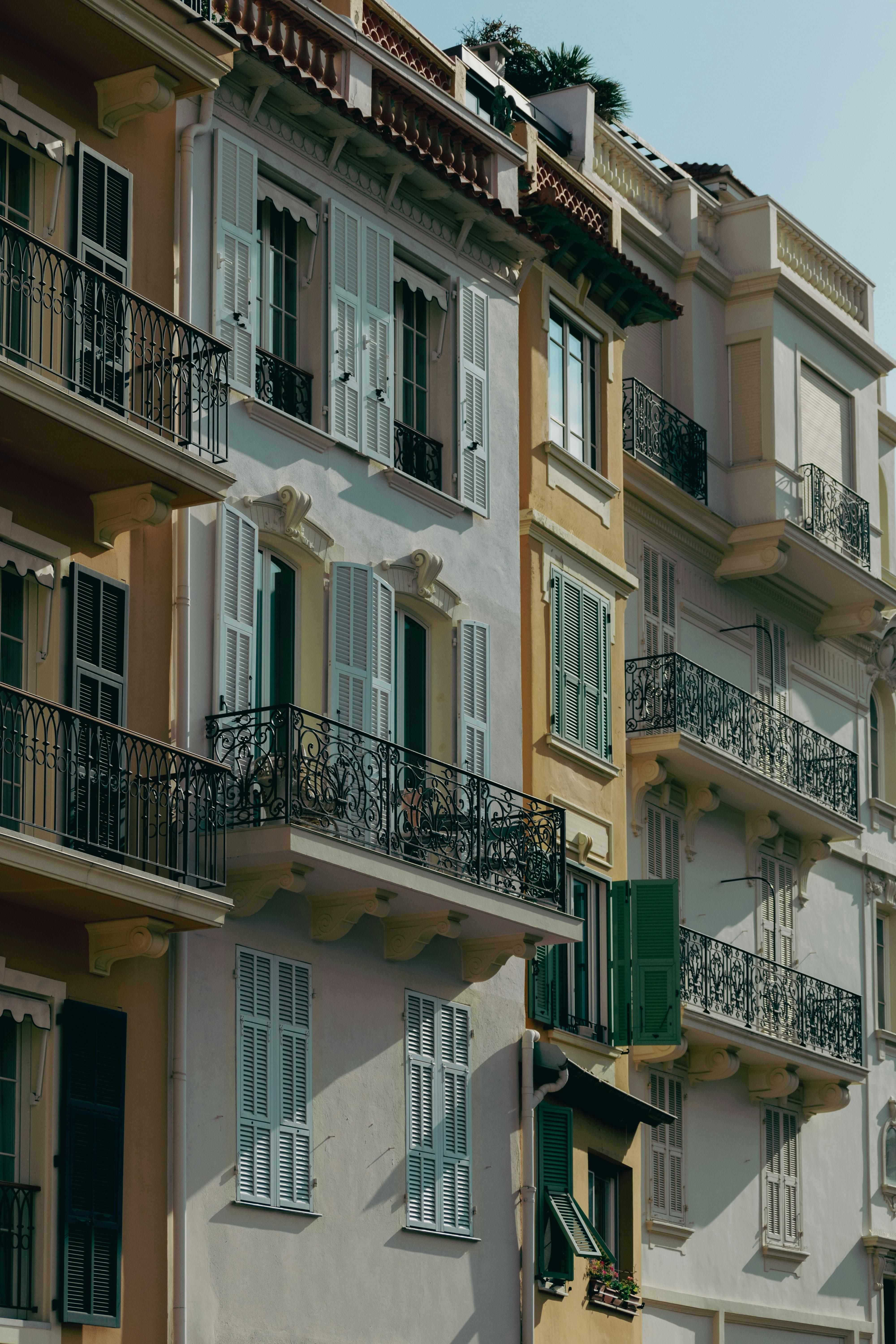 Elegant architectural details of Monte Carlo buildings with colorful facades and ornate balconies.