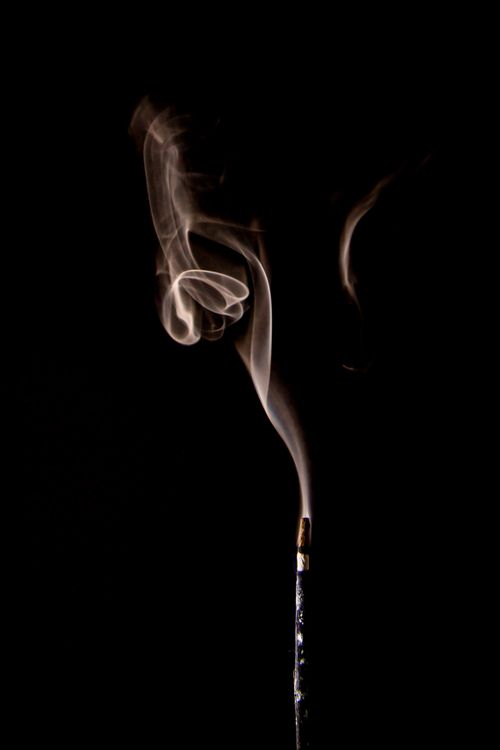 Free Captivating image of swirling incense smoke against a dark backdrop. Stock Photo