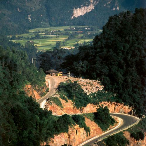 Free A winding road through lush mountains in Cao Bang, Vietnam, offering stunning natural scenery. Stock Photo