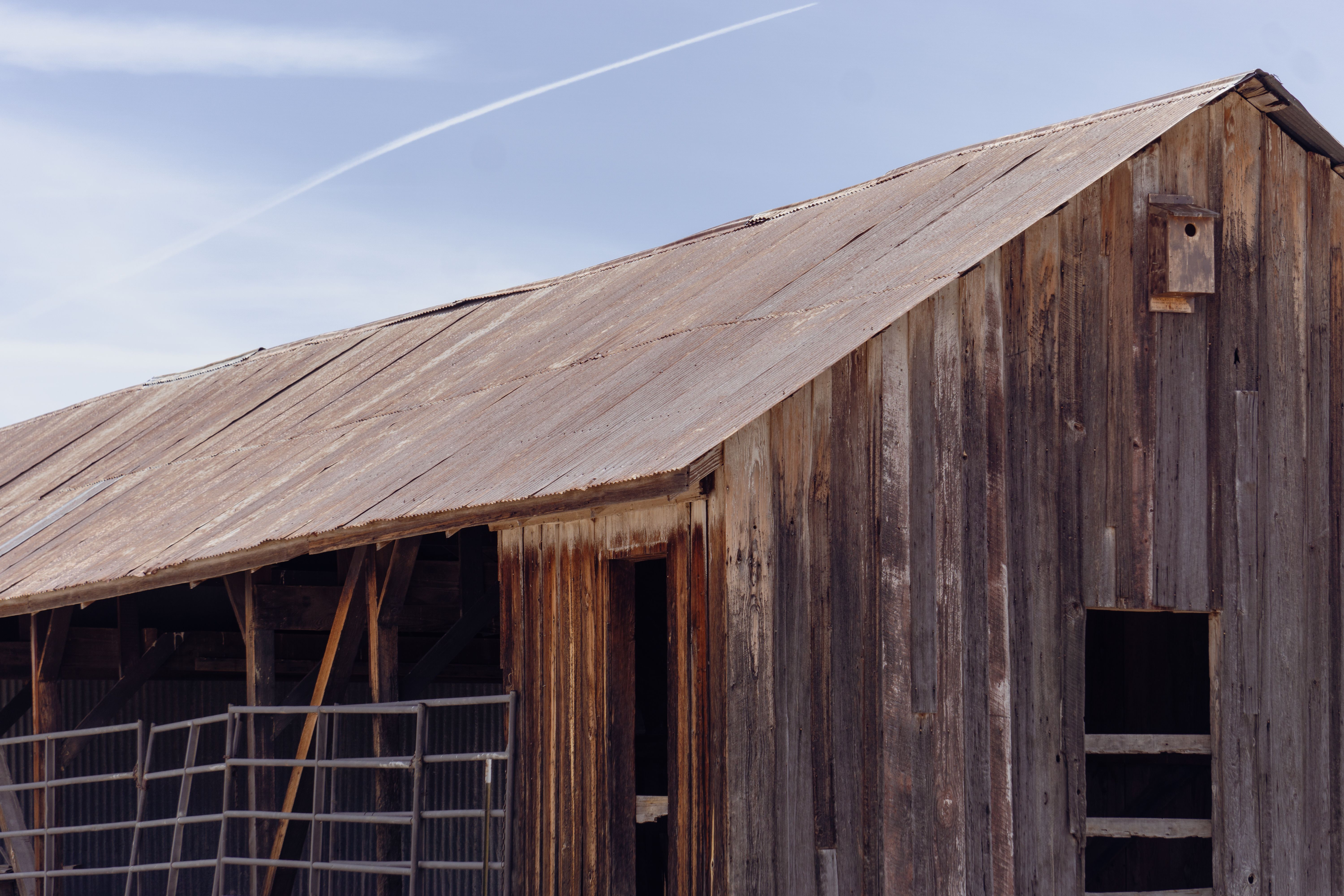 Weathered wooden barn under a clear blue Arizona sky