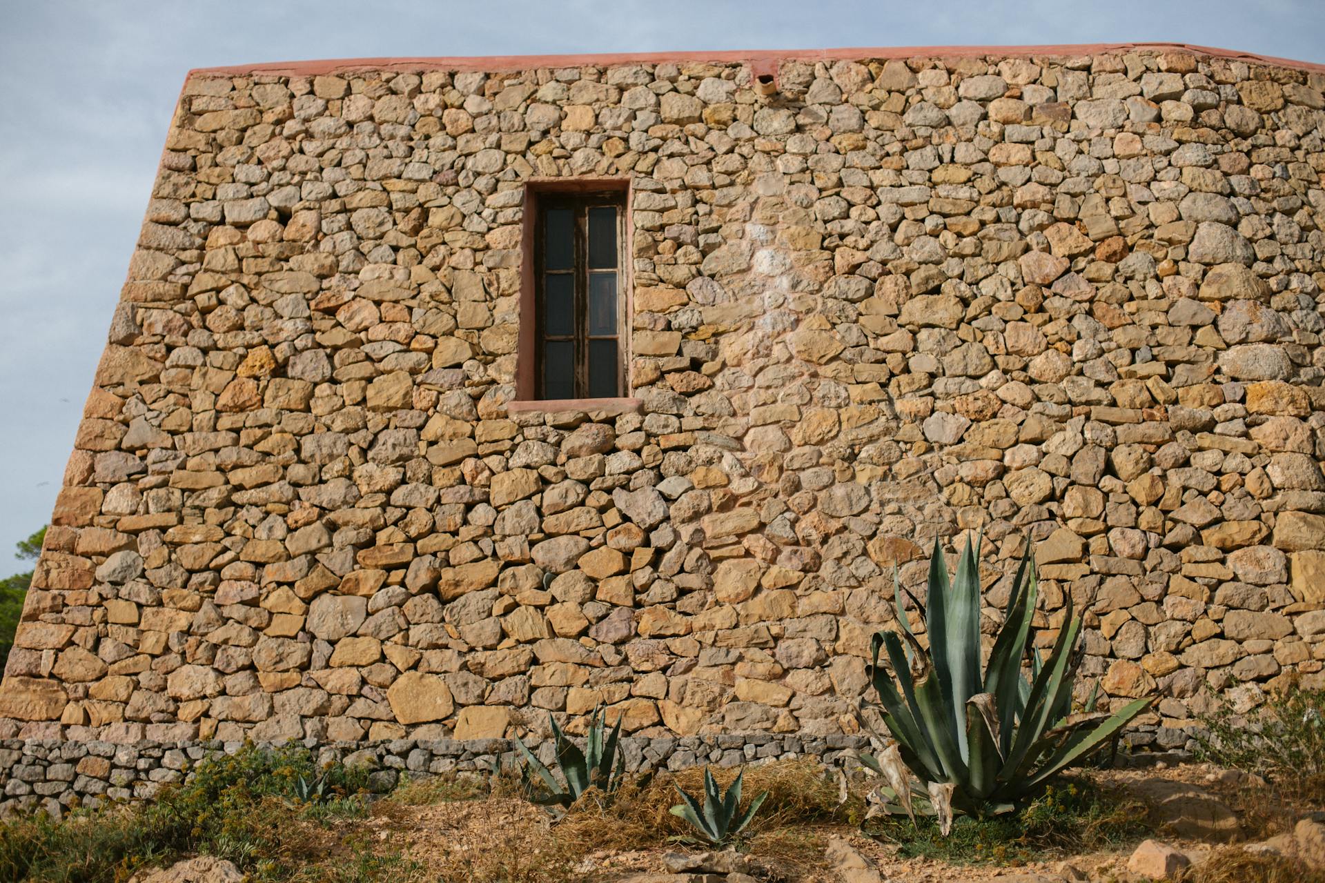 Rustic Stone Architecture in Ibiza with Agave Plants