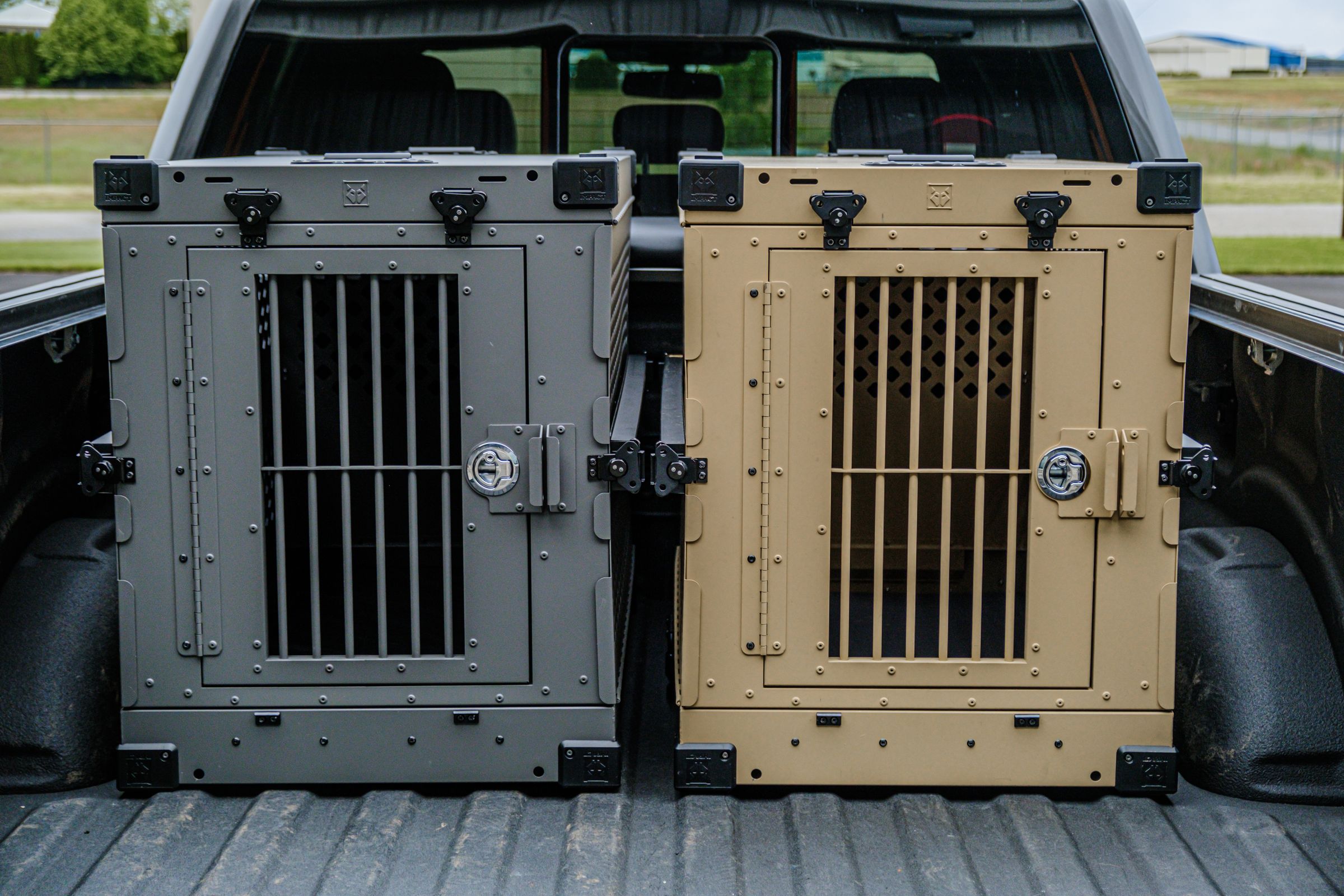 Durable dog crates loaded in the bed of a pickup truck for transport