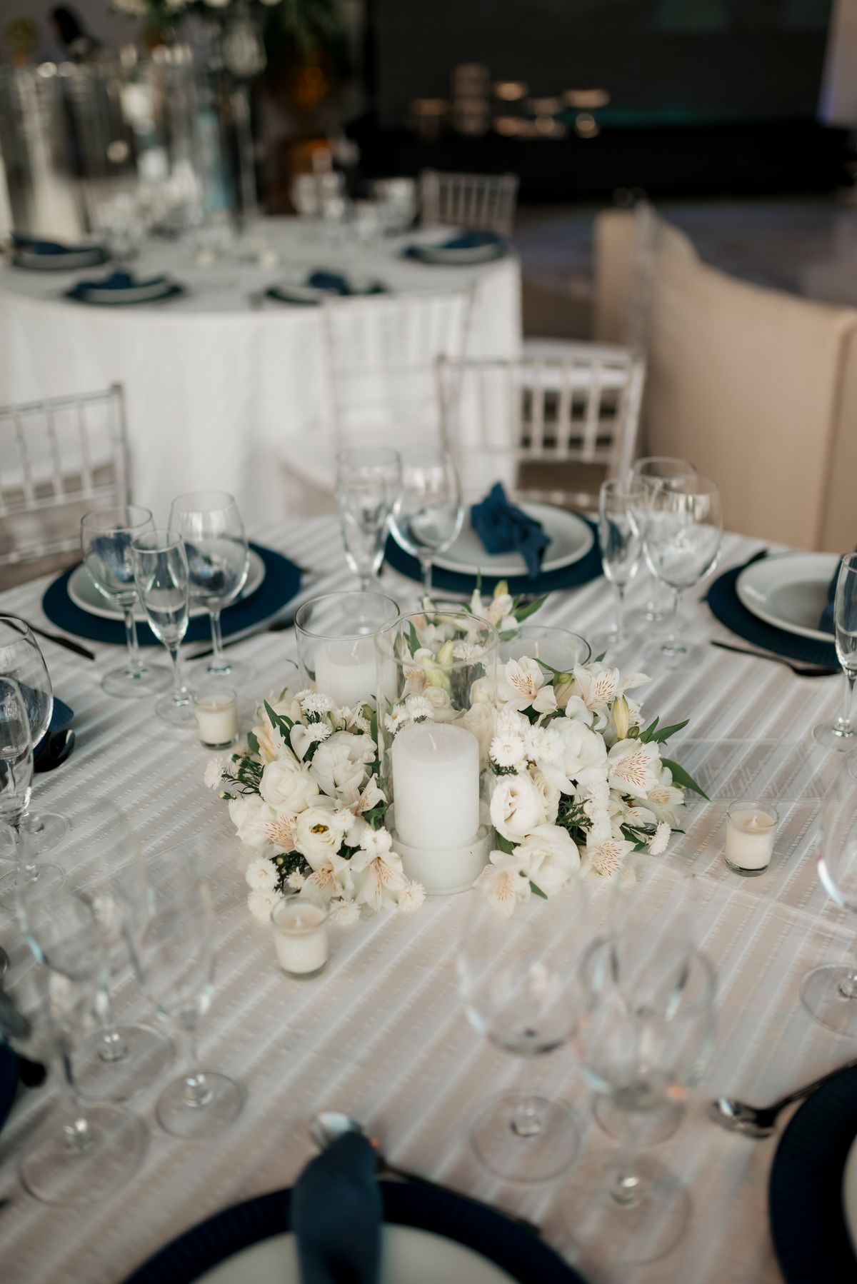 Blue and white wedding table with flowers and candles