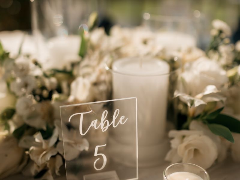 Wedding table setup with candles and white flowers