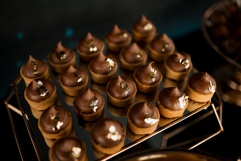 Close-up of luxurious chocolate desserts adorned with gold leaf