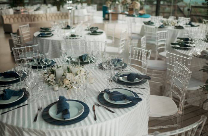 Elegantly styled tables at an indoor wedding reception