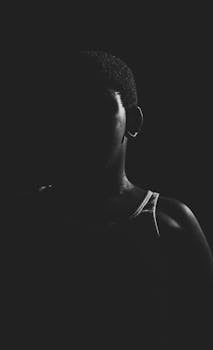 一幅黑白肖像中，人物的轮廓在戏剧性的光影中展现