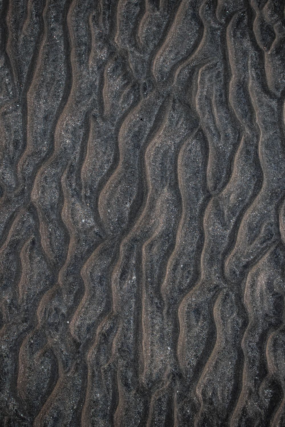 Close-up of dark engineered sand