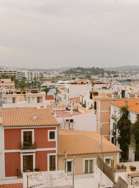 A picturesque view of tiled rooftops in Ibiza, highlighting traditional architecture and vibrant Mediterranean colors.