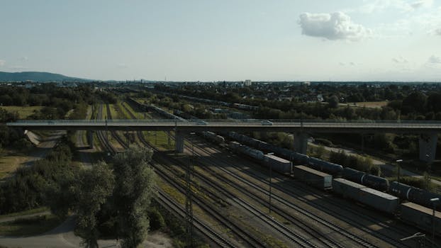 Aerial view showcasing a railway with freight train in a scenic landscape near Offenburg, Germany.