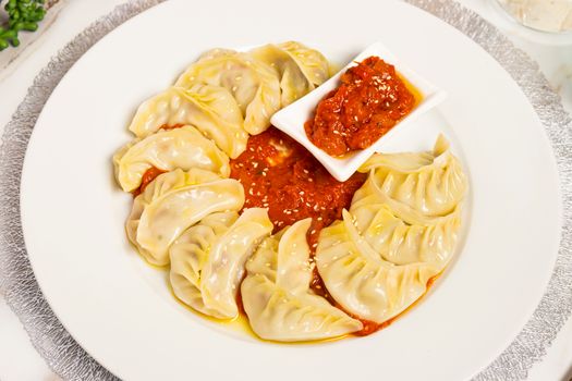 A plate of dumplings served with flavorful tomato sauce, perfect for food lovers in Sydney.
