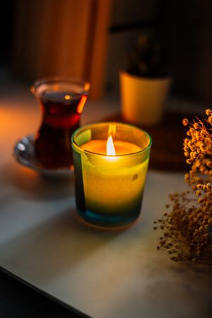 Soy candle burning in a glass jar — photo by Sedanur Kunuk on Pexels