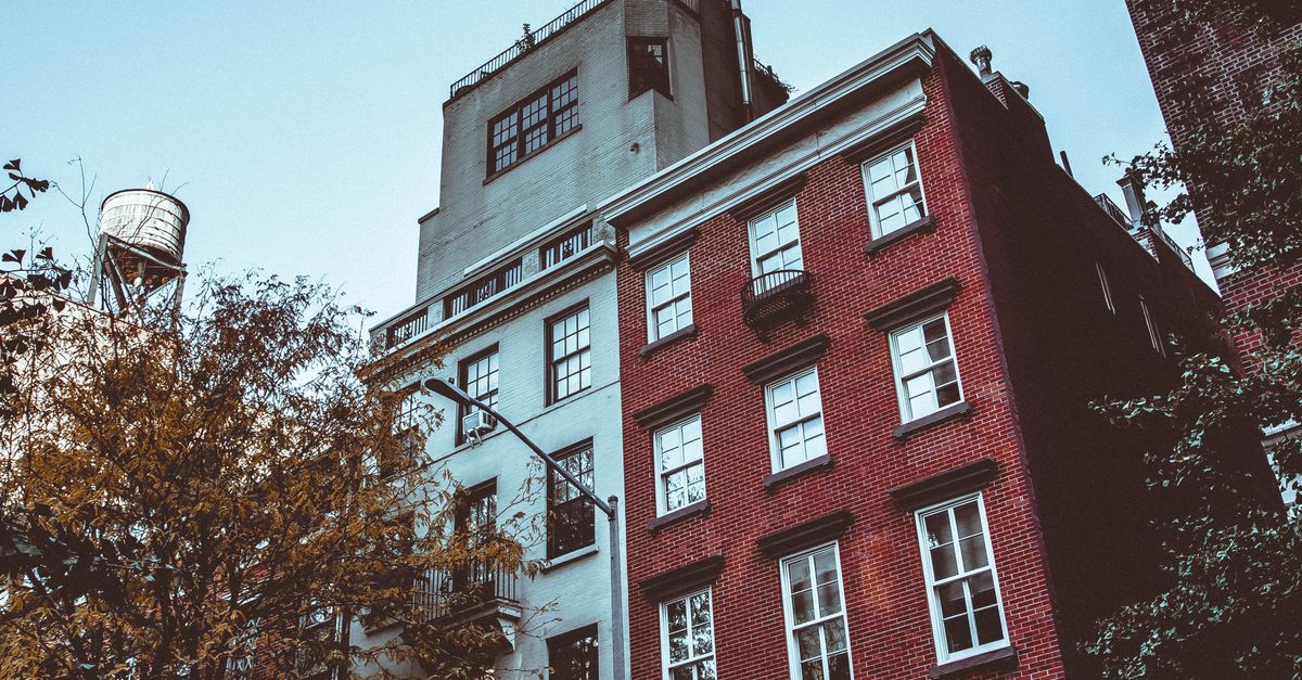 Capture of classic brick buildings with a water tower in New York's urban landscape.