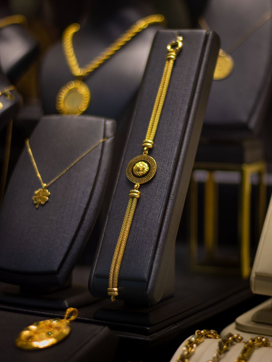 Gold jewelry on black stands in a jewelry store