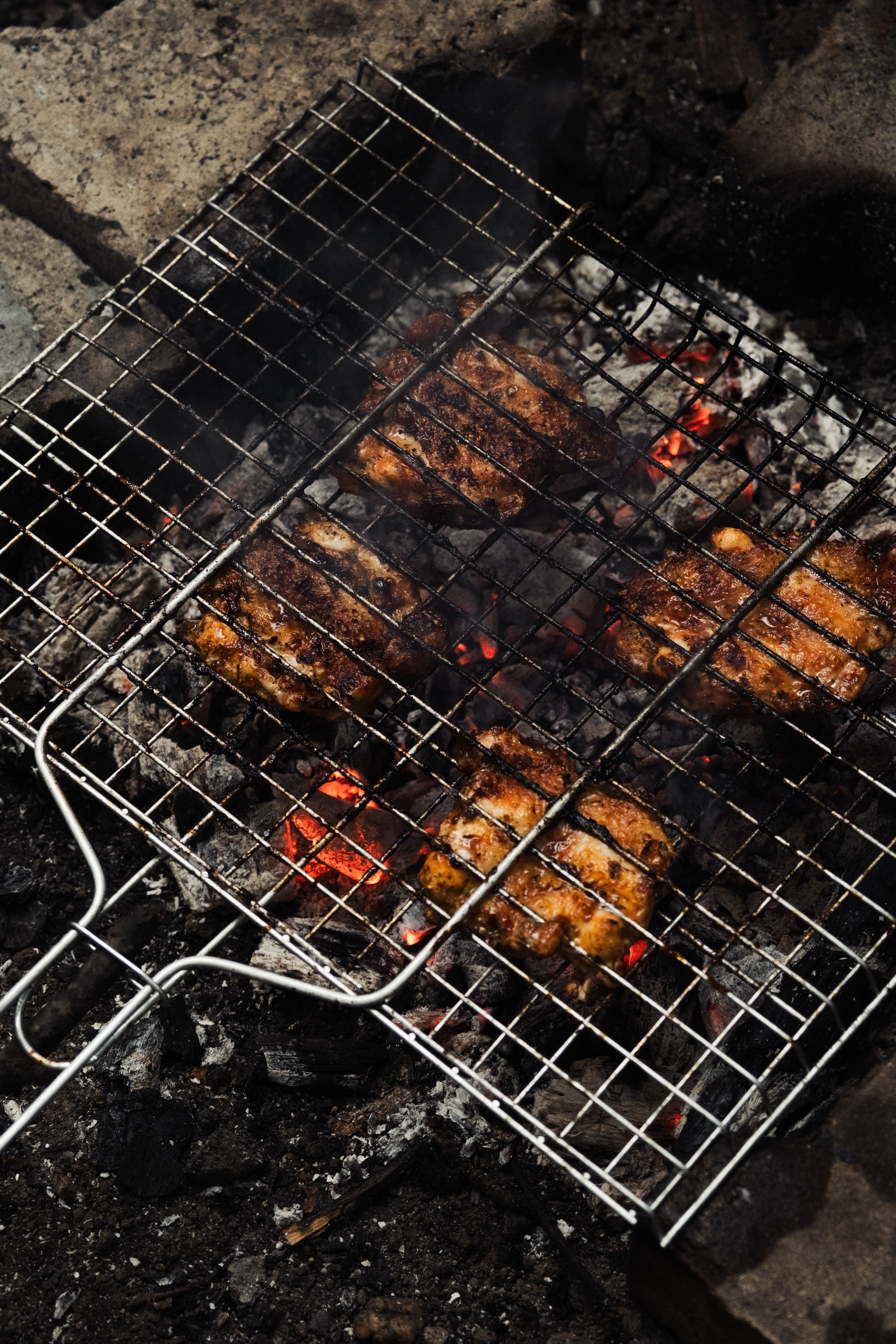 grilled meat on barbecue over open flame