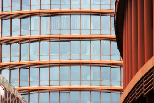 Free Close-up of a modern glass facade in Seville, showing architectural details and reflections. Stock Photo