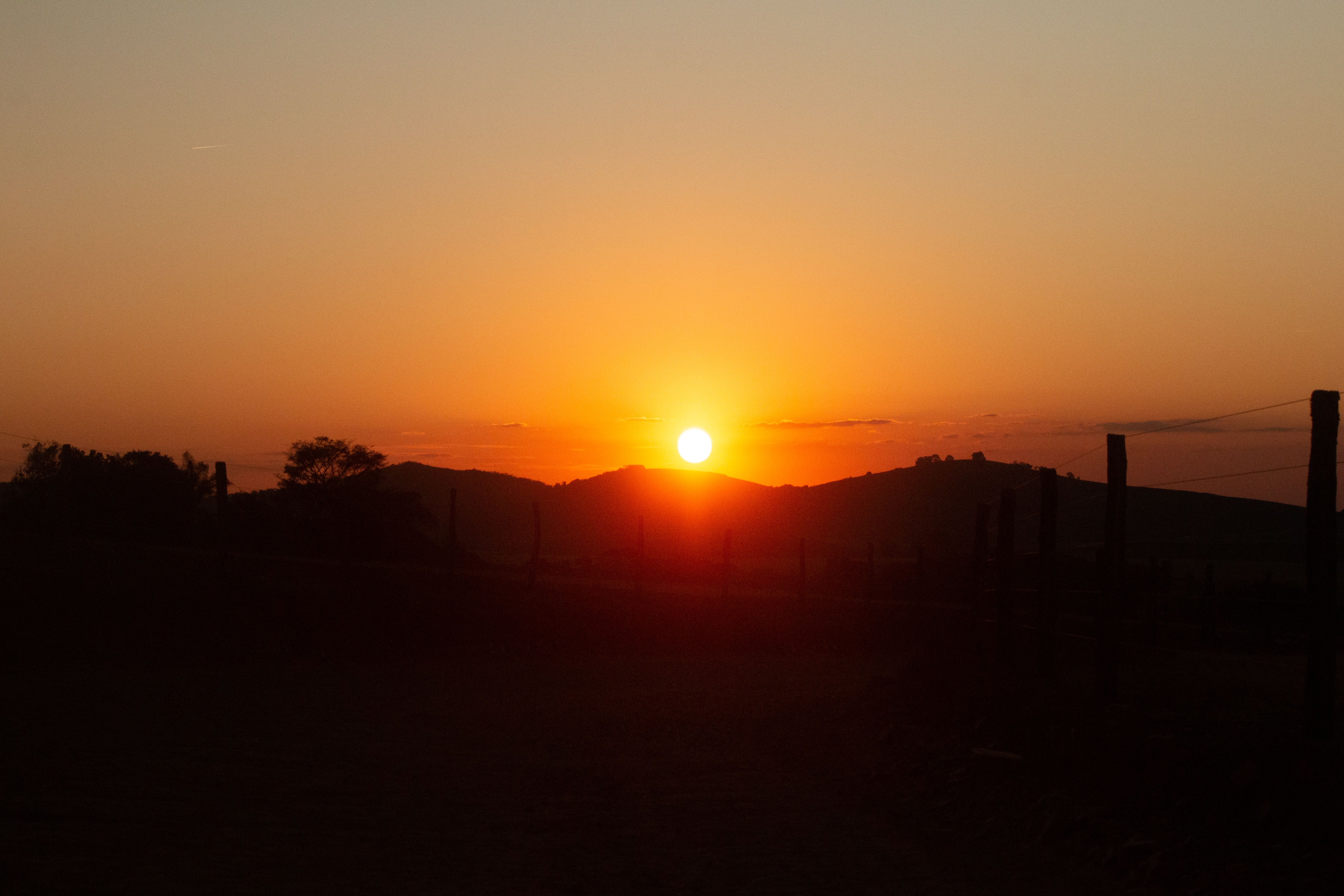 Beautiful Sunset Over Rolling Hills Landscape · Free Stock Photo