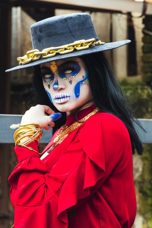 Free Portrait of a woman in vibrant Catrina makeup and costume, symbolizing Day of the Dead, in Mexico City. Stock Photo