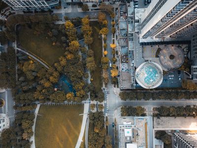 Overhead aerial of a city park hemmed in by tower blocks — Willian Justen de Vasconcellos on Pexels