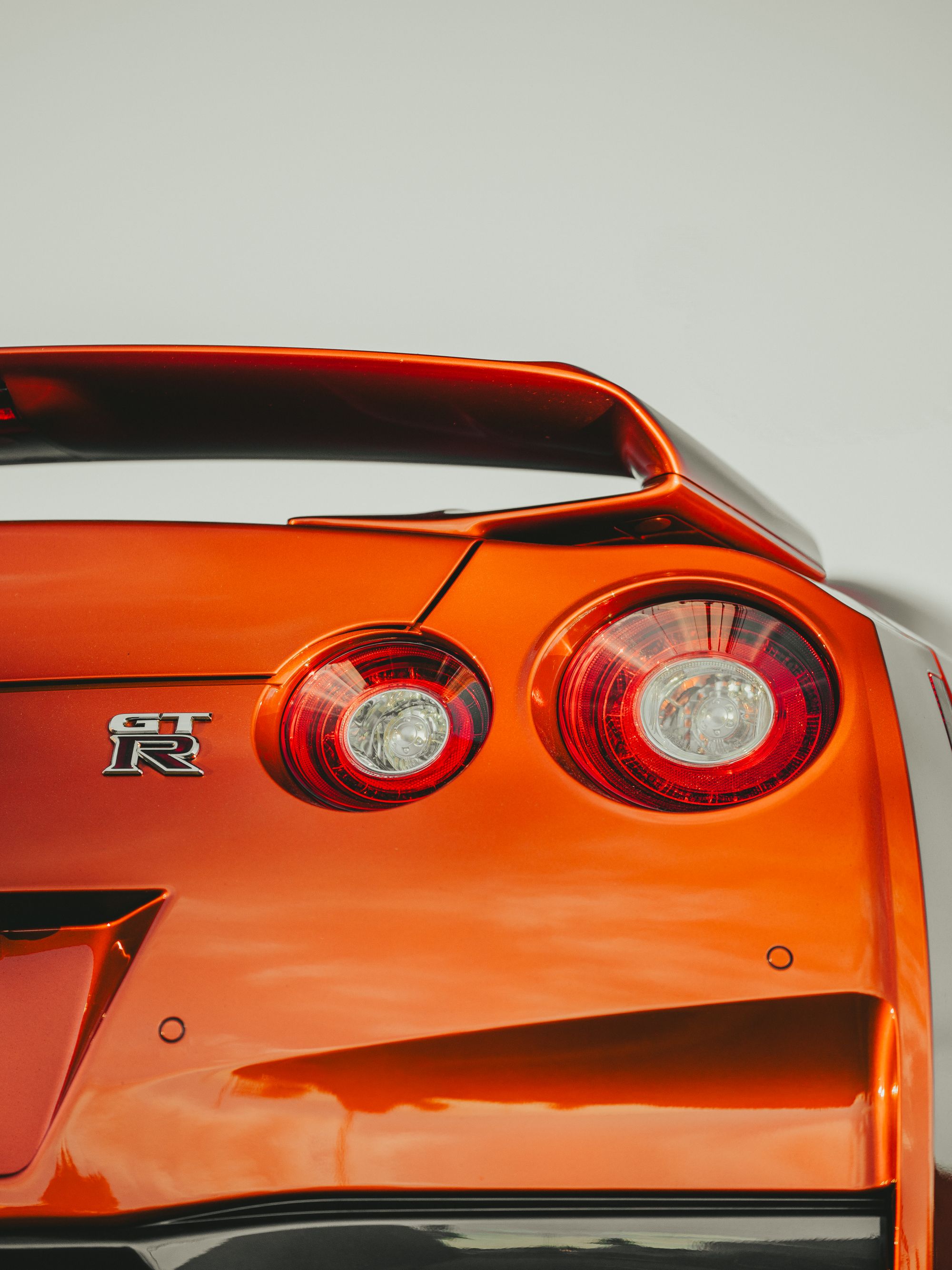Clean studio-style shot of the Nissan GT-R R35 rear end directly supports the GT-R section of the article with a bold,…