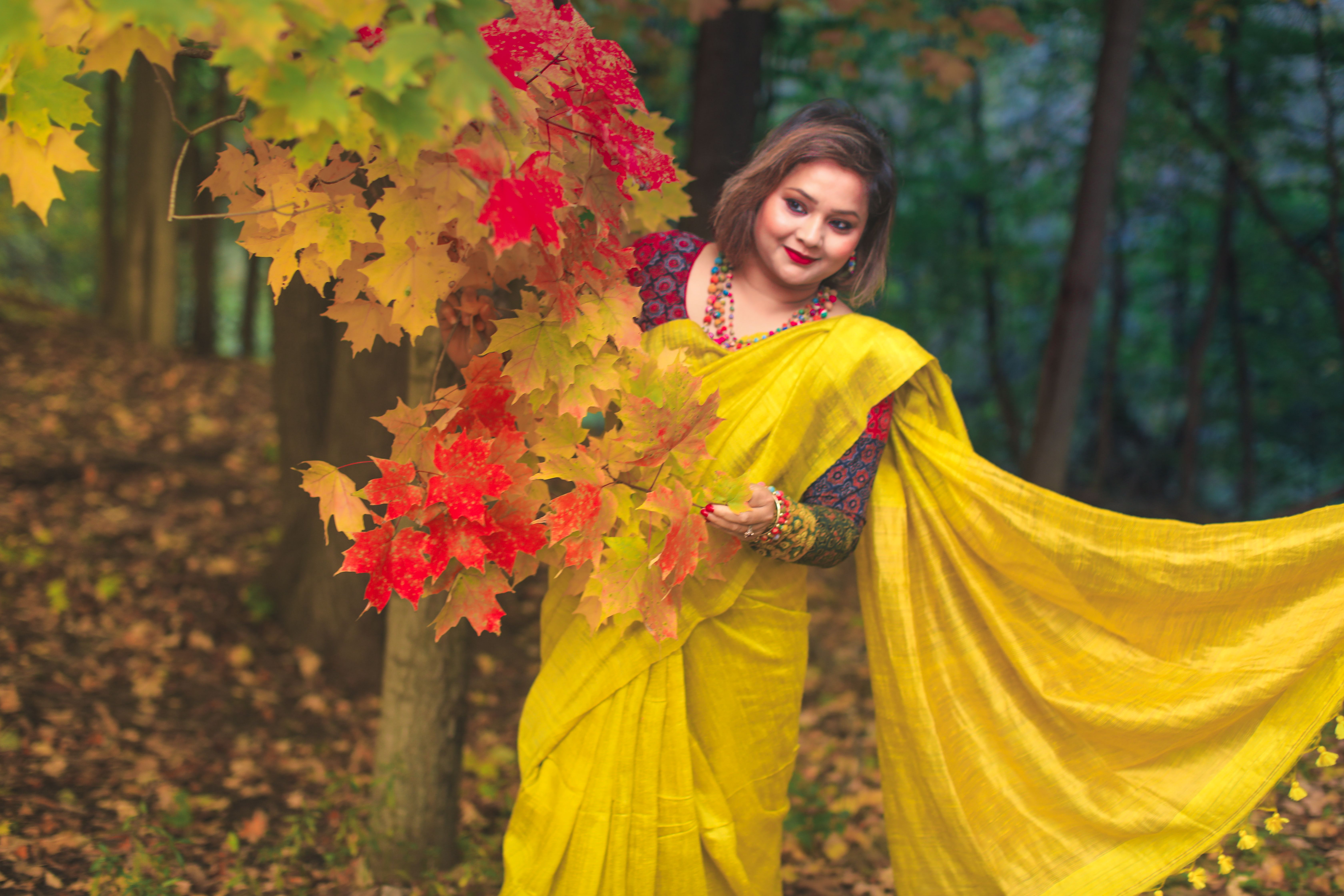 Woman in Yellow Saree with Autumn Leaves in Forest · Free Stock Photo