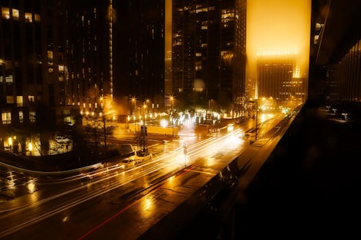 Vibrant cityscape at night featuring light trails and illuminated skyscrapers.