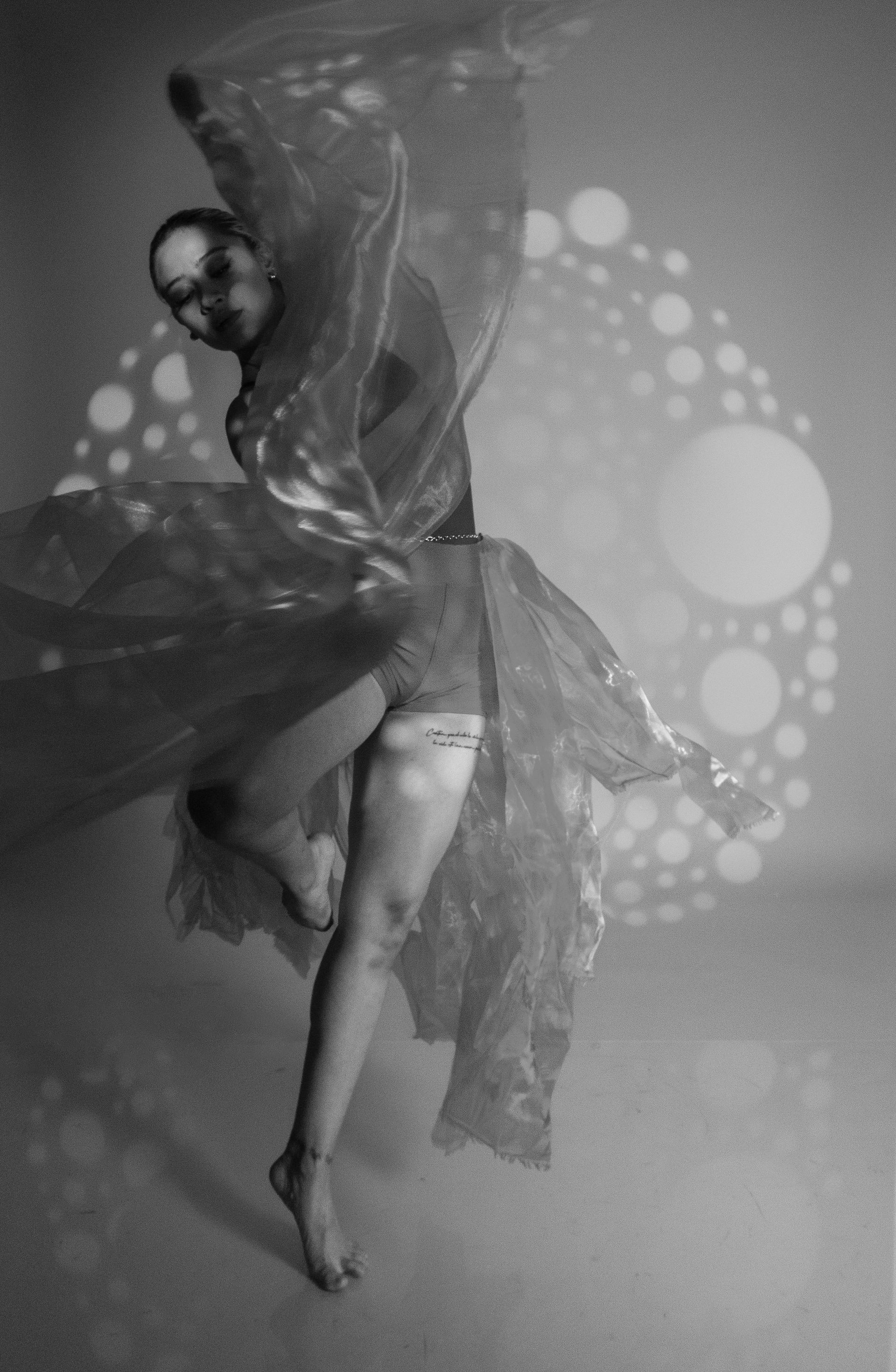 A dancer in motion with flowing fabric