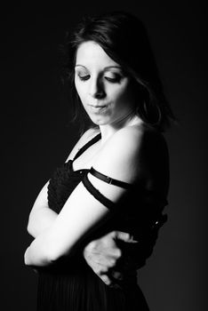 Stylish black and white portrait of a woman in a contemplative pose, adding depth and emotion.