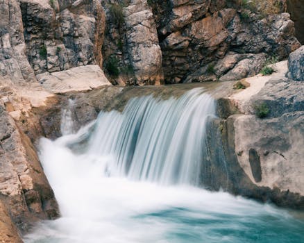 Beautiful waterfall cascading down rocky cliffs in Khyber Pakhtunkhwa, Pakistan. A serene natural retreat.