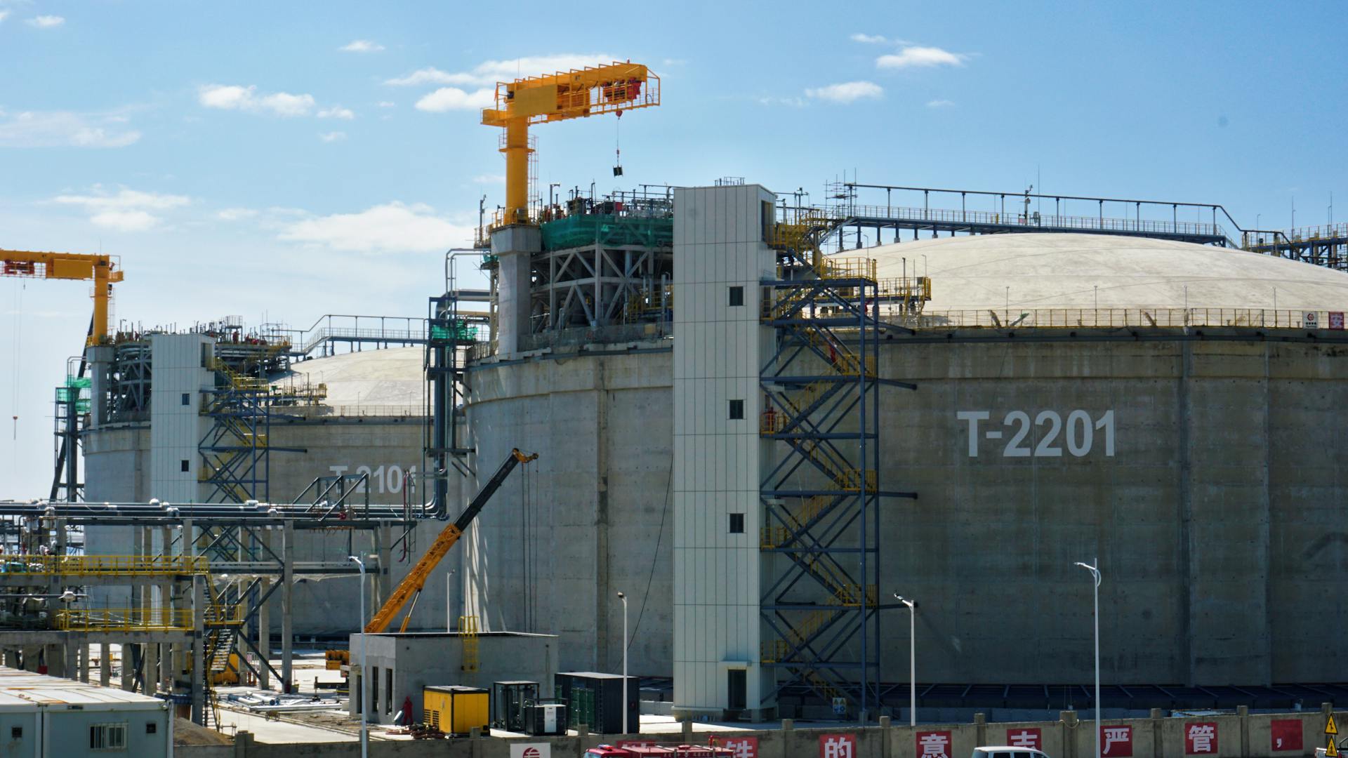 Industrial Storage Tanks with Cranes at Facility