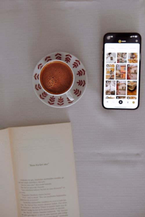 Free Top view of coffee, book, and smartphone on a white tablecloth. Stock Photo