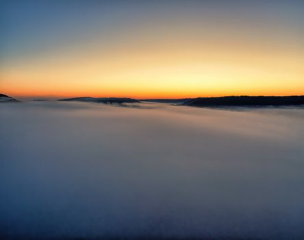 Majestic sunrise over a fog-filled valley in Tell, Wisconsin, USA.