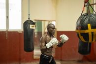 A focused boxer practices in a traditional gym, highlighting Havana's sports culture.