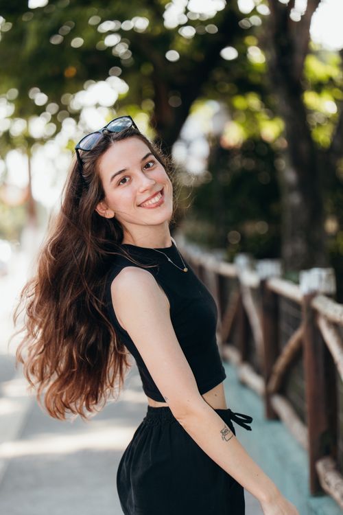 Smiling Young Woman Outdoors in Summer · Free Stock Photo
