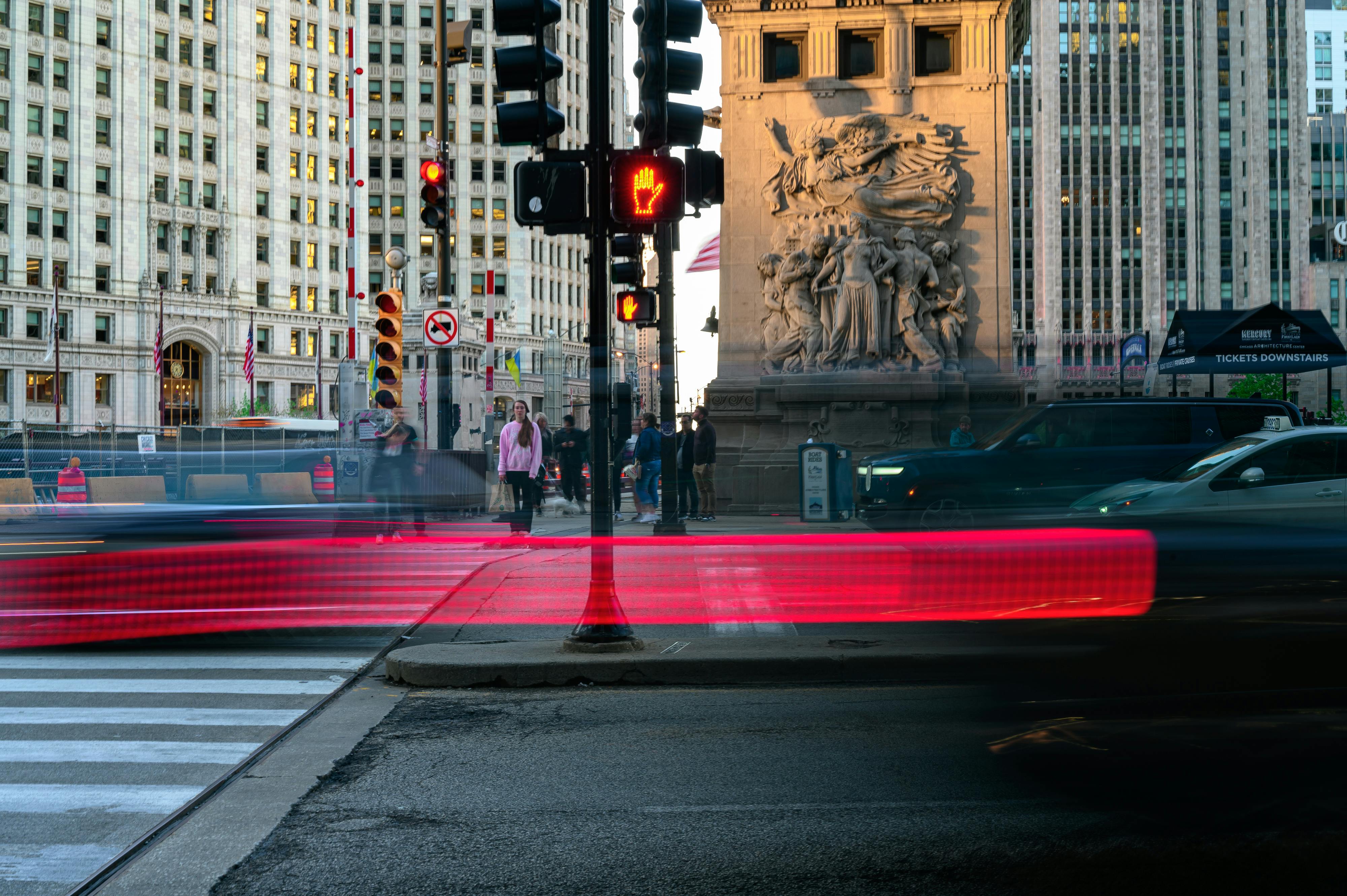 Dynamic long exposure shot of Chicago's bustling city street with light trails and architectural landmarks.