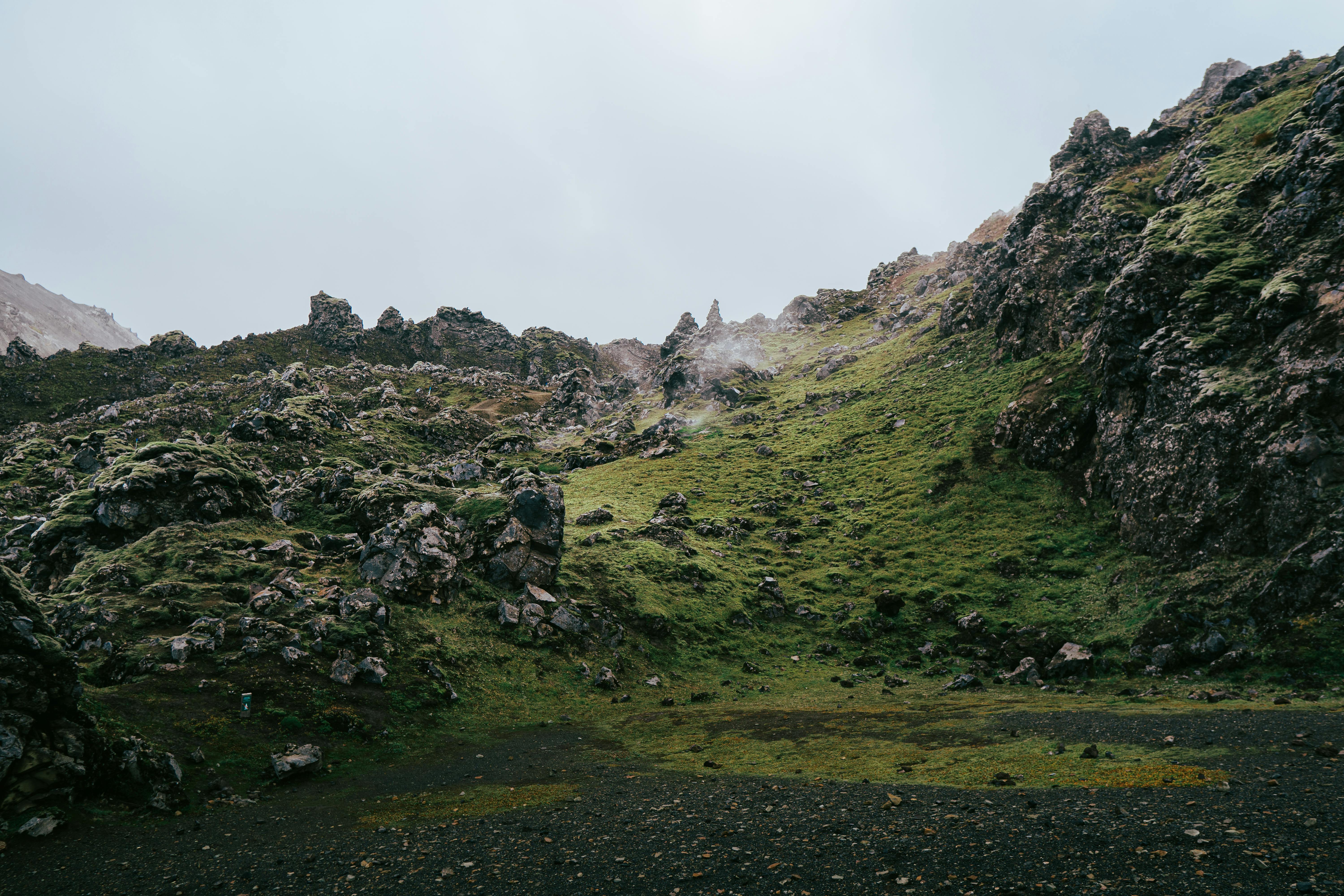 Beautiful lush green hills and rocky terrain in Iceland's Landmannalaugar region.