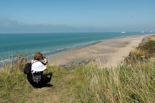 Woman Taking a Photo of the Beach and Sea 