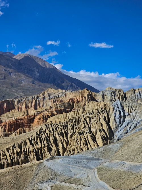 Free Dramatic rock formations under a vibrant blue sky in Mustang, Nepal. Stock Photo