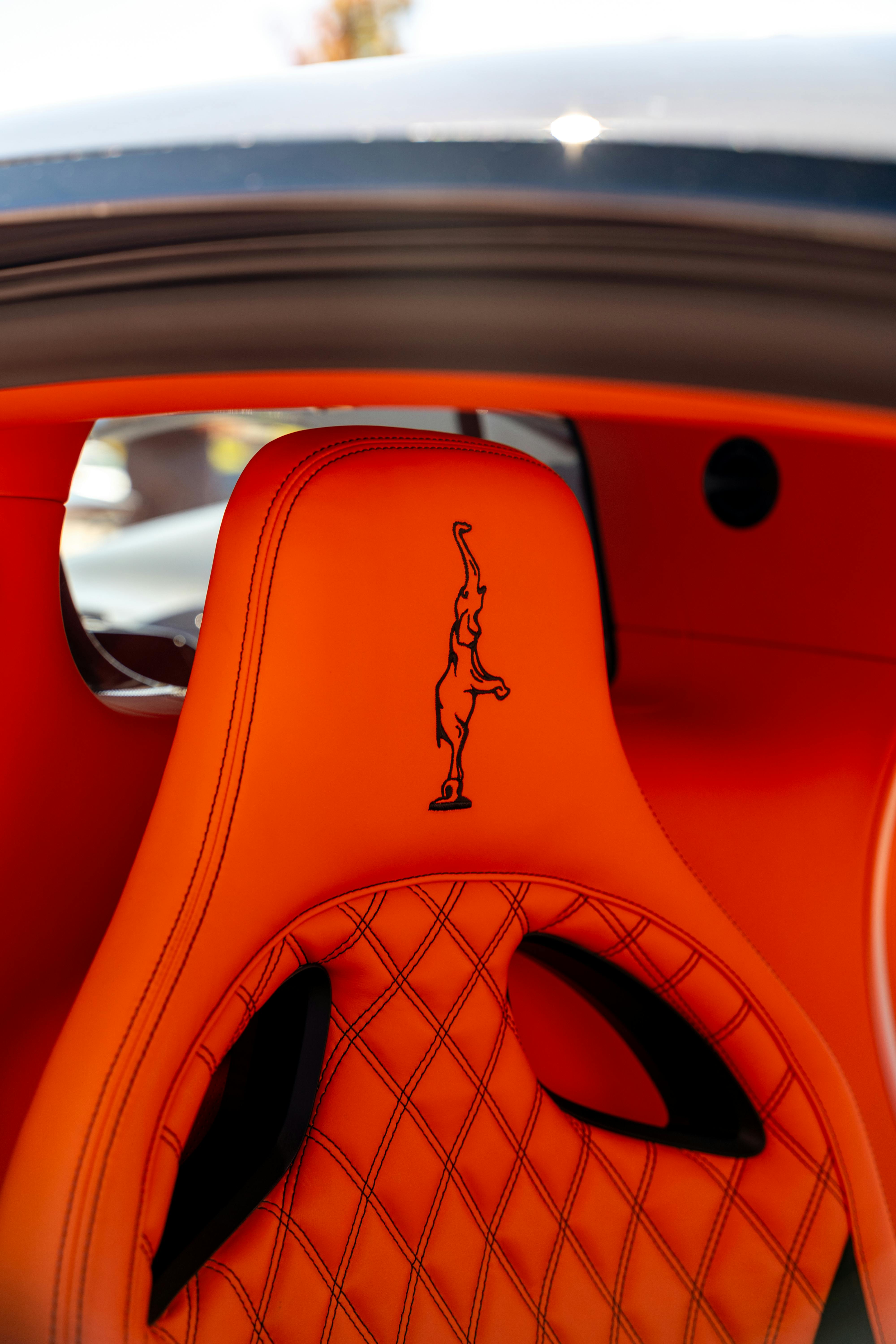 Close-up of an orange luxury car seat in a modern EV interior