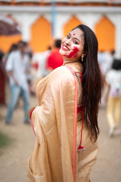 A woman in a red sari sitting on the ground · Free Stock Photo