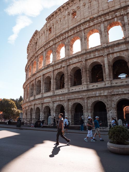 Free Historic Roman Colosseum captured in daylight with tourists exploring. Stock Photo