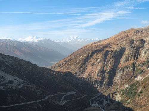 Free Stunning view of winding roads through Alpine mountains on a clear day. Stock Photo