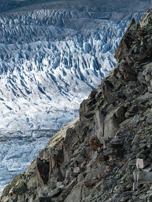 Stunning view of a glacier with rugged cliffs showcasing natural beauty.