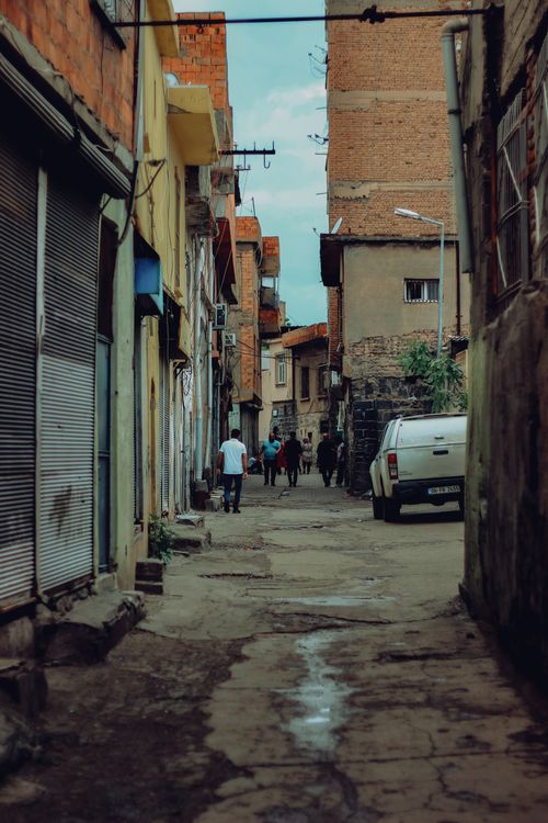 Free Urban alleyway bustling with people and vehicles, showcasing everyday life. Stock Photo