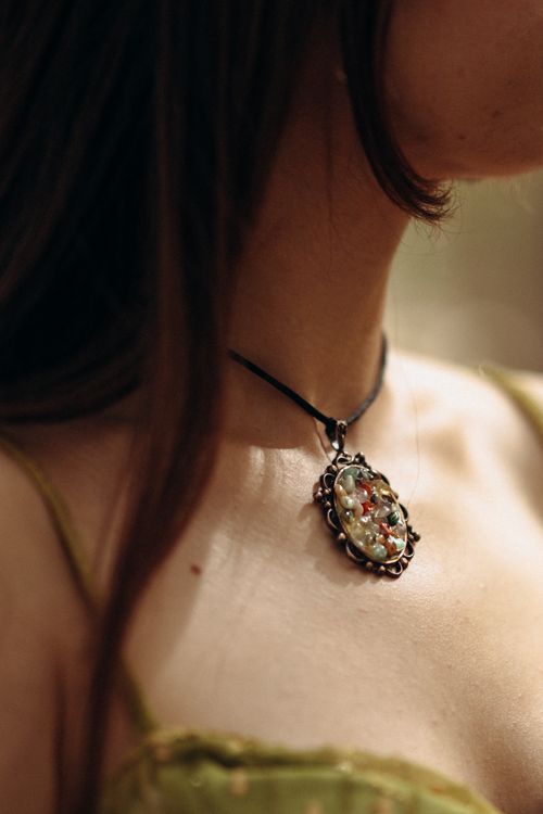 Free Close-up of an elegant necklace worn by a woman with soft lighting, creating a warm and intimate feel. Stock Photo