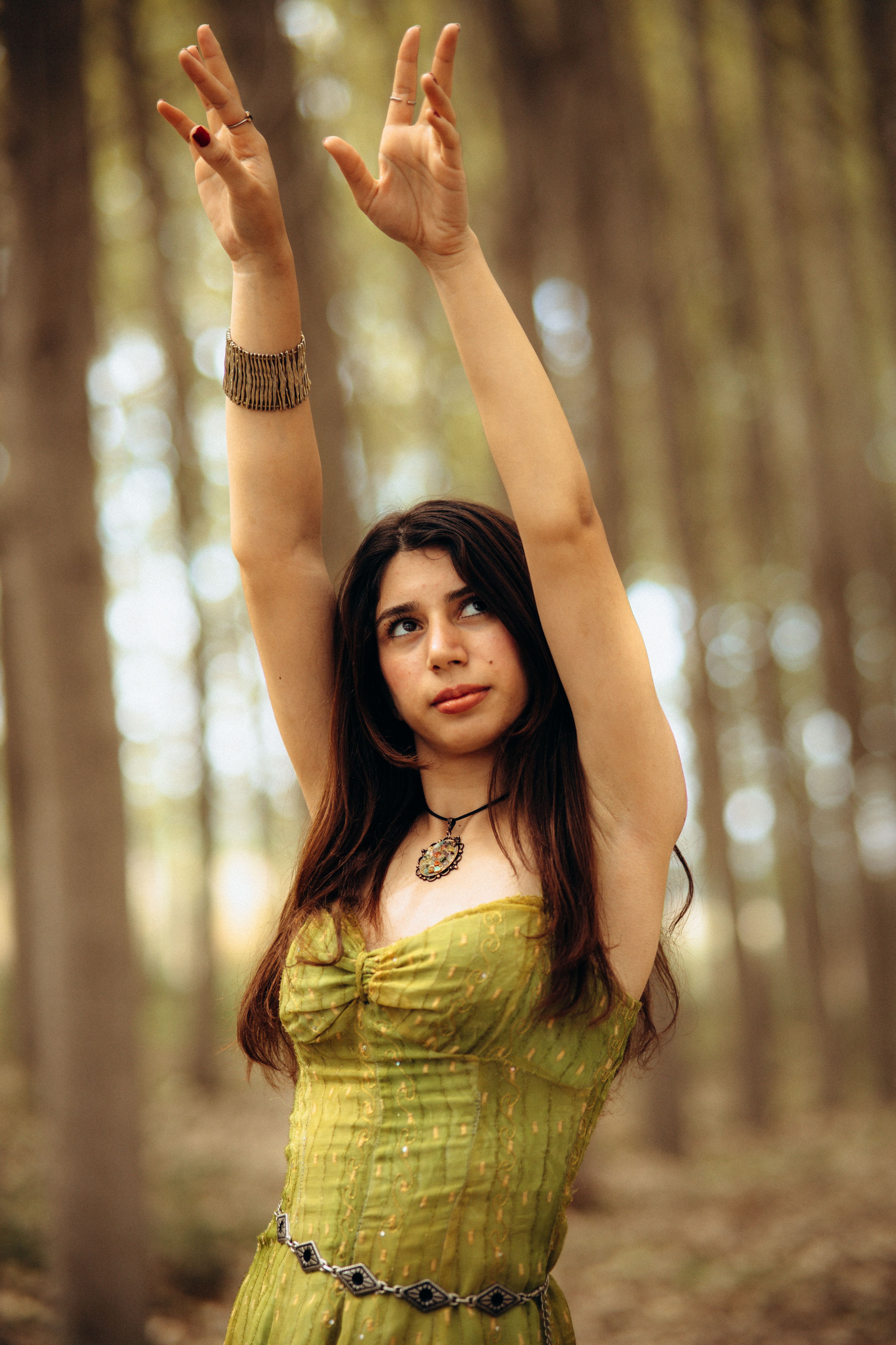 Woman in Green Dress Raising Arms in Forest · Free Stock Photo