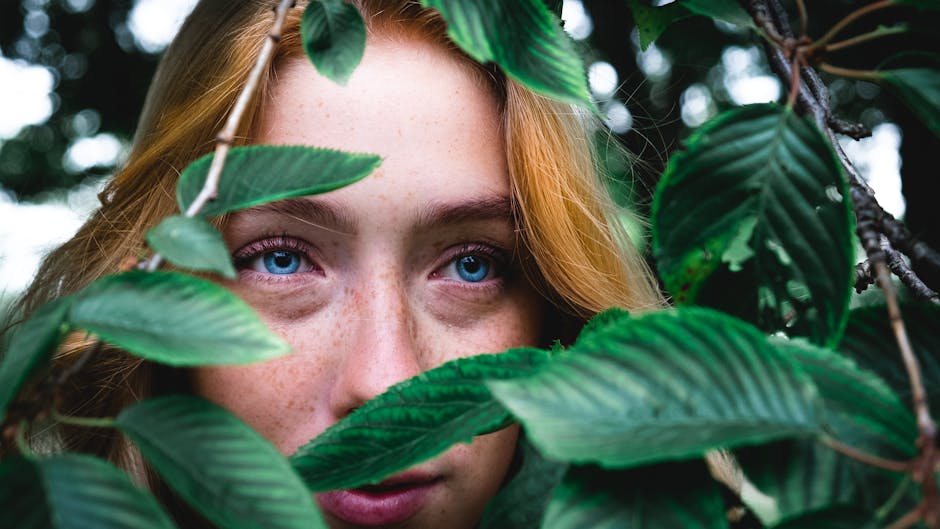 Woman's Face Behind the Leaf Close-up Photo · Free Stock Photo